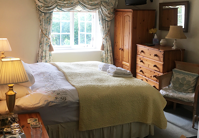 The Primrose room is a light, airy room with a kingsized bed at Higher Biddacott Farm, perfect for a summer holiday. 